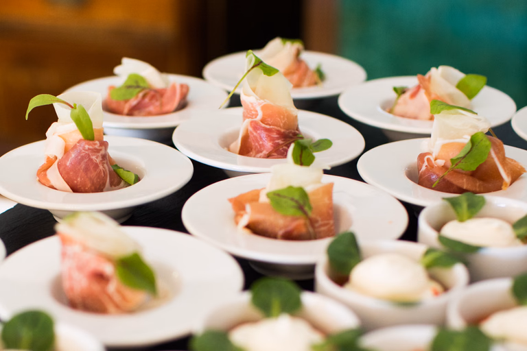 Rows of plated canapes garnished with fresh herbs