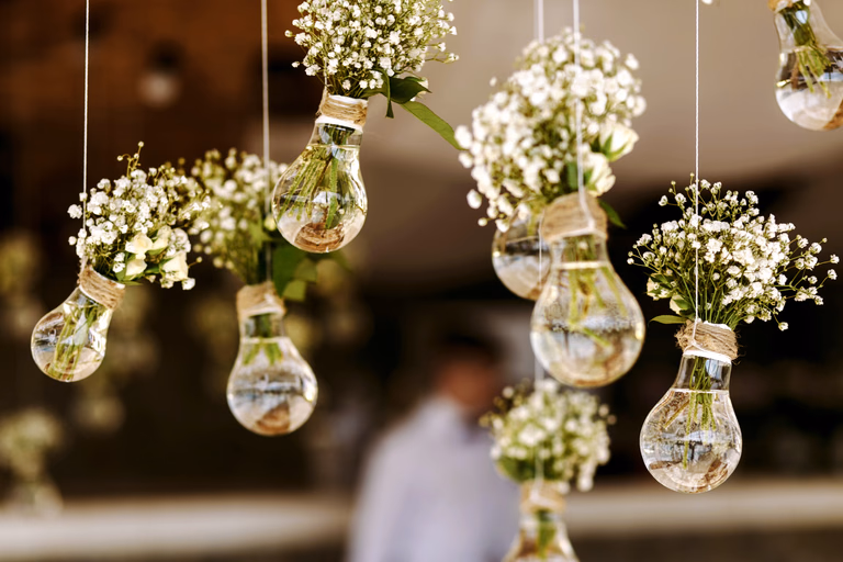 Sprigs of baby's breath suspended in glass globes above a reception