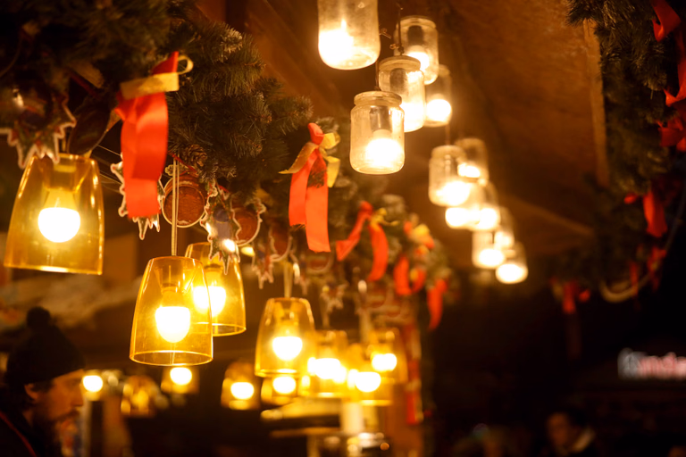 Candlelit mason jar lanterns hanging from tree branches